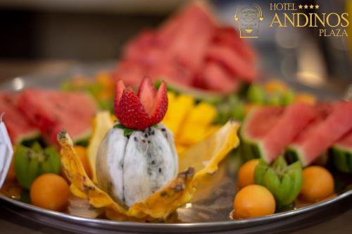 a plate of fruit with a flower on top at Hotel Andinos Plaza Florencia in Florencia