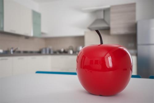 a red apple sitting on a table in a kitchen at Residenza Picalof in Nago-Torbole