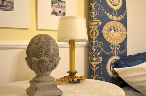 a lamp sitting on a table next to a bed at Piano8 in Asola