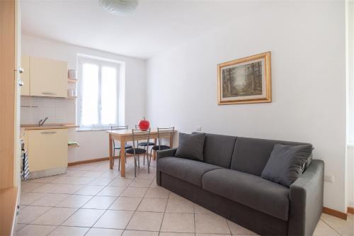 a living room with a couch and a table at Residenza Picalof in Nago-Torbole