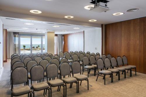 a room with a bunch of chairs in a room at Sesimbra Oceanfront Hotel - Preferred Hotels and Resorts in Sesimbra