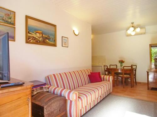 a living room with a couch and a tv at Apartment Kameo in Dubrovnik