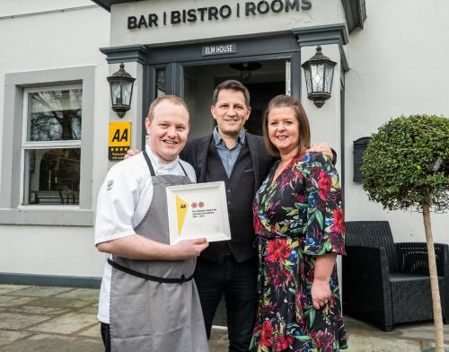 a man and a woman holding an award at 1863 Restaurant with Rooms in Pooley Bridge