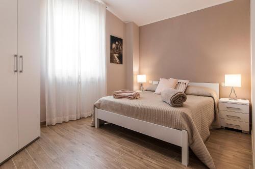 a bedroom with a large bed and a window at Sunset Home Sperlonga - Allogio per uso turistico Giulia Sabella in Sperlonga