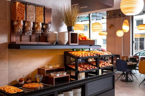 a bakery with a bunch of food on display at voco Strasbourg Centre - The Garden by IHG in Strasbourg