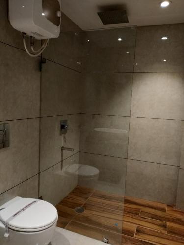 a bathroom with a toilet and a shower at Hotel Star Inn in Gangānagar