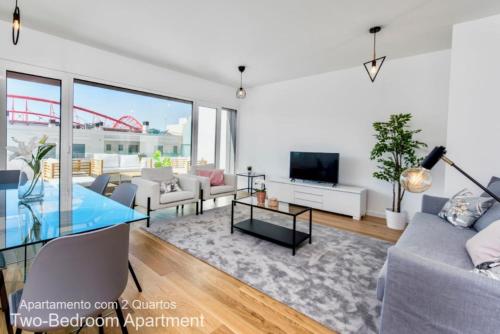 a living room with a couch and a tv at Akicity Benfica Stadium in Lisbon