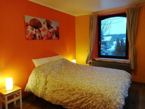 a bedroom with a bed and a window at Au bord de l'Eau in Bastogne