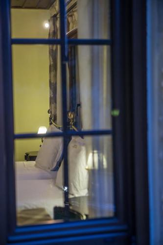 a window with a view of a bed with towels at Archontiko Lydia Lithos in Órma