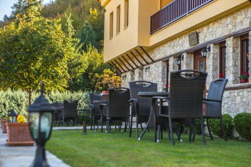 a group of chairs and tables outside of a building at Archontiko Lydia Lithos in Órma