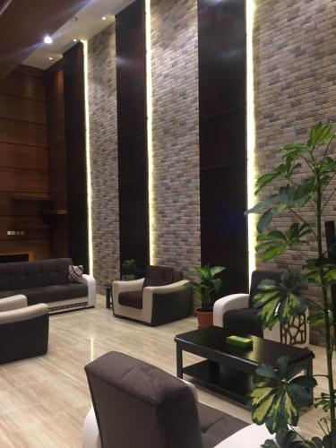 a lobby with couches and plants at تاج الخليج للشقق المخدومة in Dammam