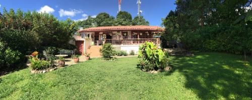 a house in a yard with a green lawn at Real House Salento in Salento