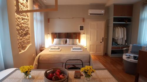 a bedroom with a bed with a bowl of fruit on a table at The "Fan" studio in the heart of Old Corfu Town in Corfu Town