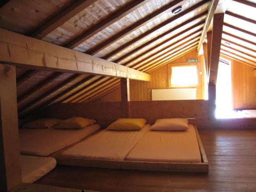 a bed in the middle of a room at Dortoir Moubra in Crans-Montana
