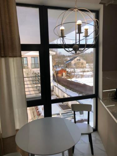 a table and two chairs in front of a window at Motel Kurortnyy & SPA in Shklo