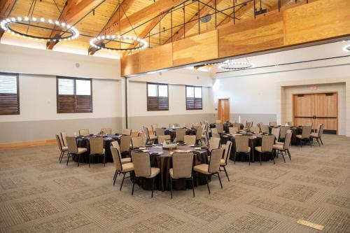 a banquet hall with tables and chairs in a room at Texican Court, by Valencia Hotel Collection in Irving