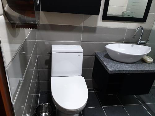 a bathroom with a white toilet and a sink at The Beauty Hotel in Gangneung