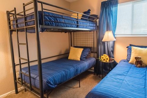 a bedroom with two bunk beds and a teddy bear at Mountain Song in Colorado Springs