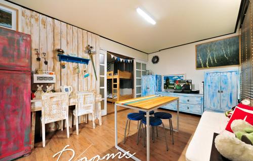 a dining room with blue cabinets and a wooden table at Jarasum Guest House in Gapyeong