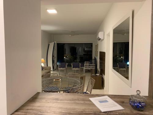 a view of a living room with a table and chairs at Las Dunas in Cabo Frio