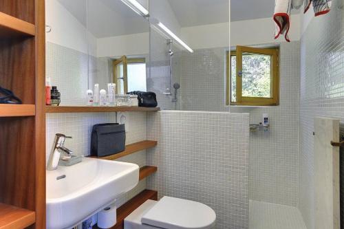 a bathroom with a white sink and a toilet at Villa Mala Villa in Krnica