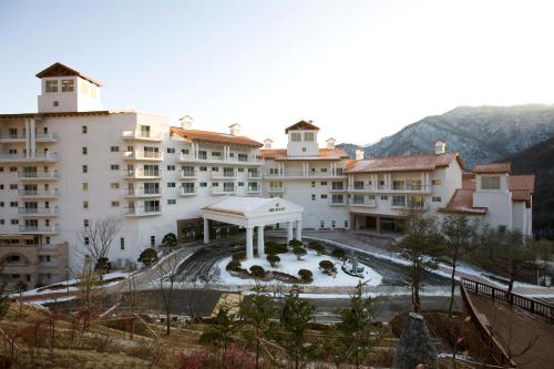 a large building with a courtyard in front of it at STX Resort in Mungyeong