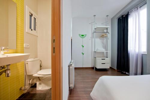 a bathroom with a sink and a toilet and a sink at Hostal Nitzs Bcn in Barcelona