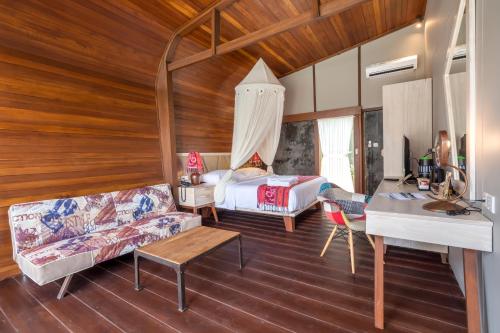 a living room with a bed and a couch at Mola2 Resort Gili Air in Gili Islands