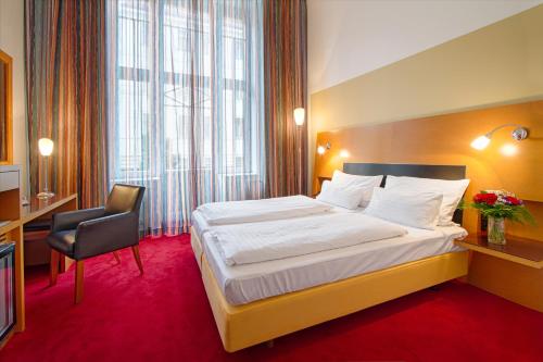 a hotel room with two beds and two lamps at Theatrino Hotel in Prague