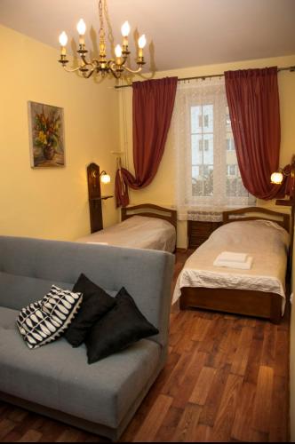 a living room with two beds and a couch at Apartament Parkowy in Sandomierz
