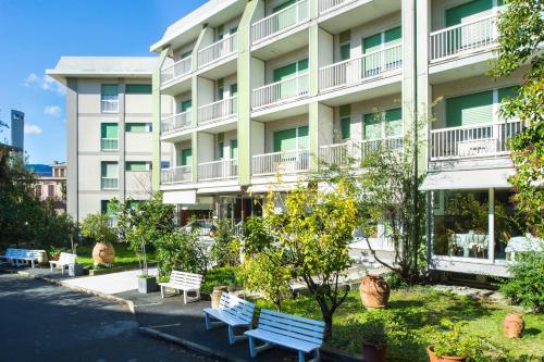 un bâtiment avec bancs devant lui dans l'établissement Hotel Ghironi, à La Spezia