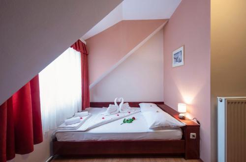 
a bedroom with a white bed and white walls at B&B Garestin in Varaždin
