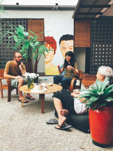 a group of people sitting around a table at Yu Cafe Hostel in Songkhla