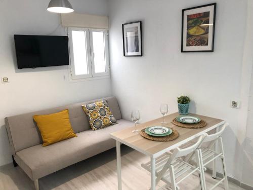 a living room with a couch and a table at CH II Apartments ZONA DE OCIO NOCTURNO in Conil de la Frontera
