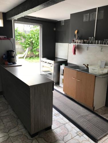 a kitchen with black walls and a counter top at Les Bananiers in Les Cocos