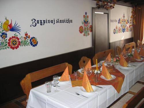 a group of tables with white table cloths on them at Hotel Strážnice in Strážnice