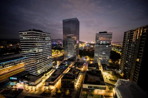 a city skyline with tall buildings at night at Guangzhou Laiste ApartHotel Science City Greenland Central Plaza Branch - Free Shuttle Bus to Canton Fair Complex During Canton Fair Period in Guangzhou