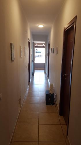 a room with a door open and a suitcase on the floor at Etna Parking in Catania