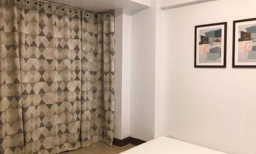 a bathroom with a shower curtain in a room at F-10C Parkside Villas in Manila