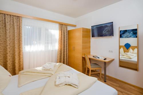 Ένα ή περισσότερα κρεβάτια σε δωμάτιο στο Aparthotel Alpendiamant Serfaus Wachter GmbH