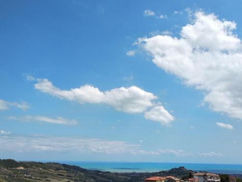 a blue sky with white clouds and the ocean at B&B Palazzo Mestichelli Boutique Palace in Monteprandone