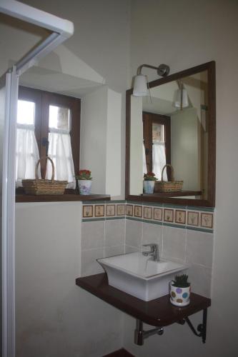 a bathroom with a sink and a mirror at Casa Lao II in El Pito