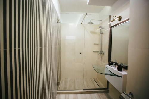 a bathroom with a shower and a glass sink at Briana Luxury Studio in Cluj-Napoca