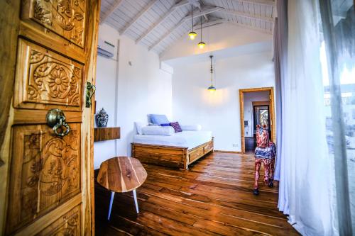a room with a bed and a table and a door at Amanta Beach in Nilaveli