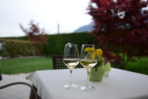 two glasses of white wine sitting on a table at Al Brenta in Levico Terme