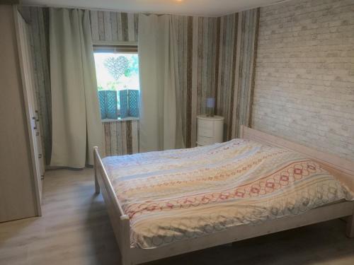 a bedroom with a large bed with a brick wall at Hof Larina in Schleswig