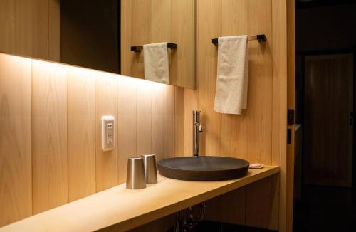 a bathroom with a black sink on a counter at Reikaku Kiyomizu Gojo in Kyoto