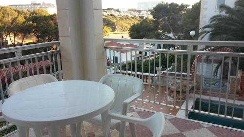 a white table and chairs on a balcony at Las Belisas in Arenal d'en Castell