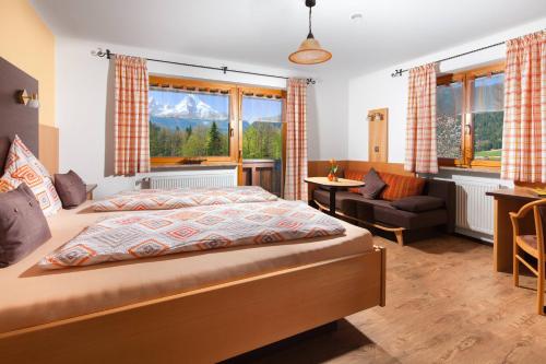 a bedroom with a bed with a view of a mountain at Pension Elvira in Bischofswiesen