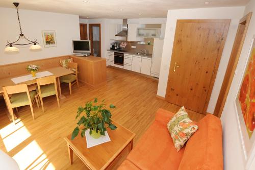 a living room with a couch and a table at Landhaus Berthold in Gargellen